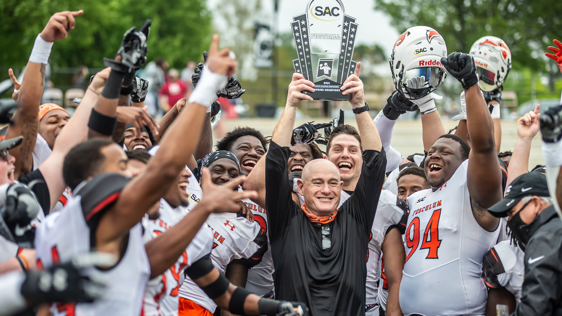 The Pioneers and head coach Jerry Odom celebrate winning Saturday's South Atlantic Conference football championship (photo by Phil Polito)
