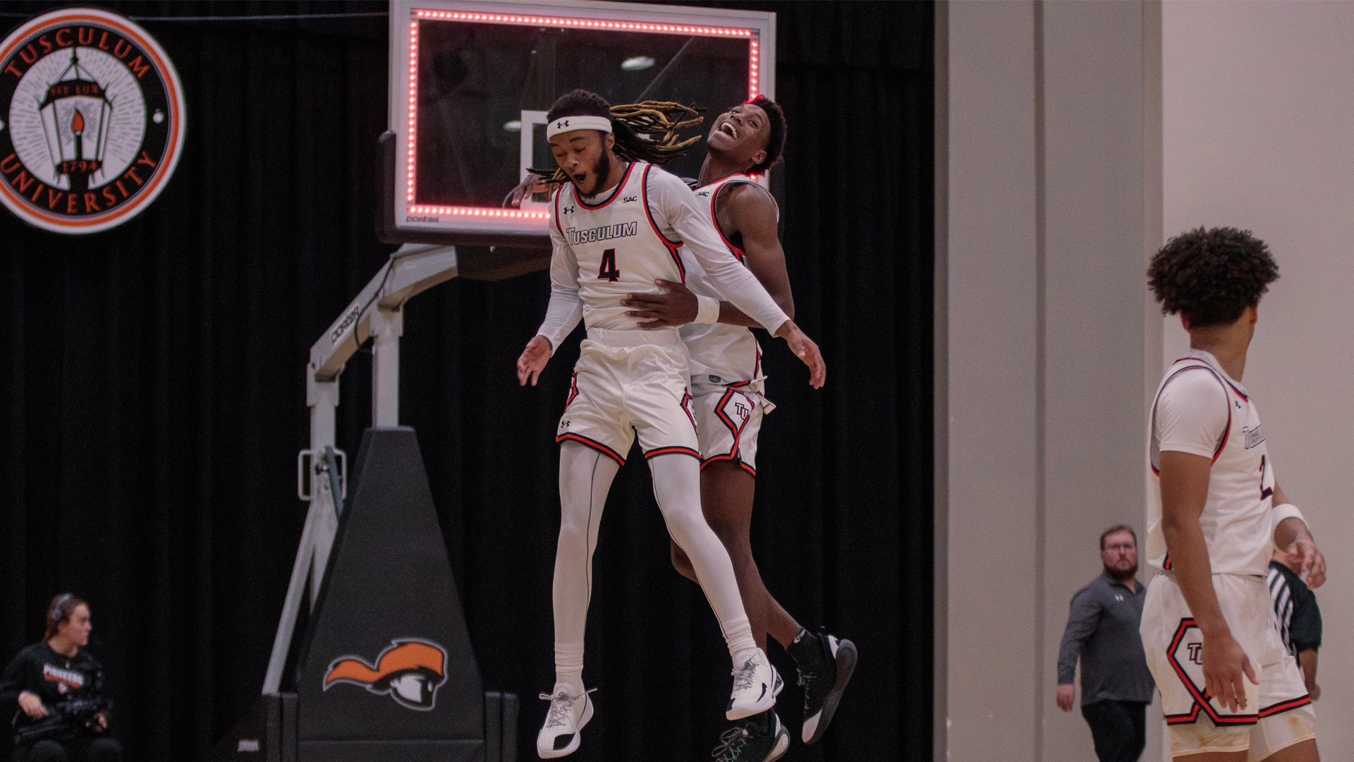Denaj Kimber and TJ Printup celebrate following Tusculum's 70-68 SAC win over Coker (photo by Kari Ham)